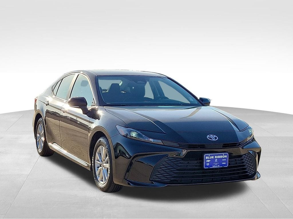 2025 Toyota Camry LE in Midnight Black Metallic — front three-quarter view